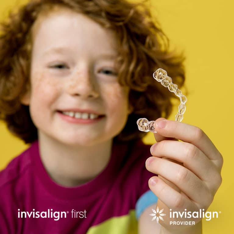kid showing invisalign